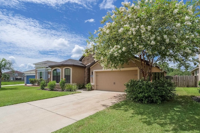 view of front of home with a garage and a front lawn