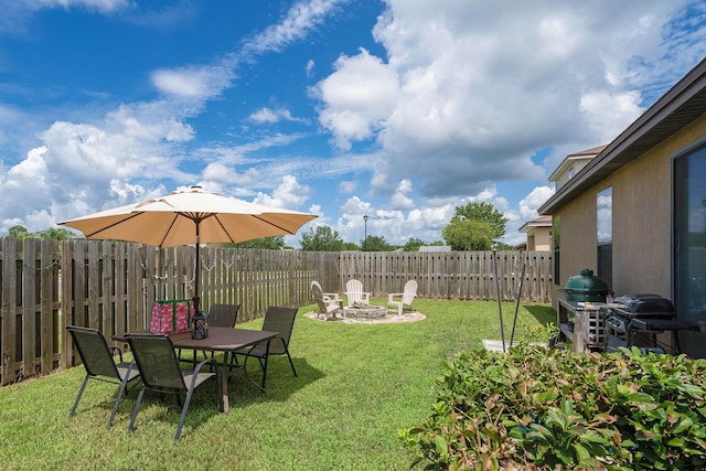 view of yard featuring an outdoor fire pit