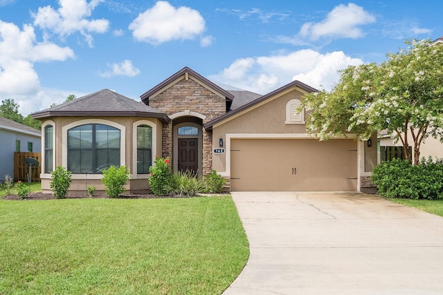 view of front of property with a garage and a front yard