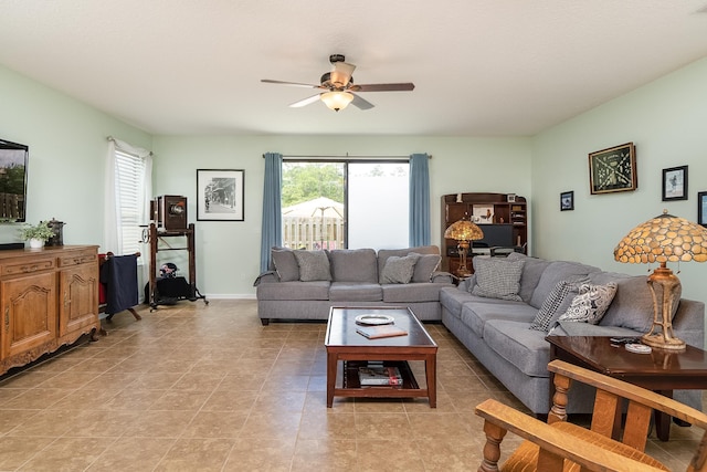 tiled living room featuring ceiling fan