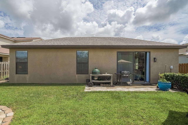 rear view of property with a patio area and a yard