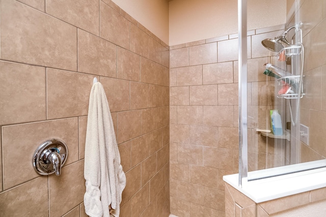 bathroom with a tile shower