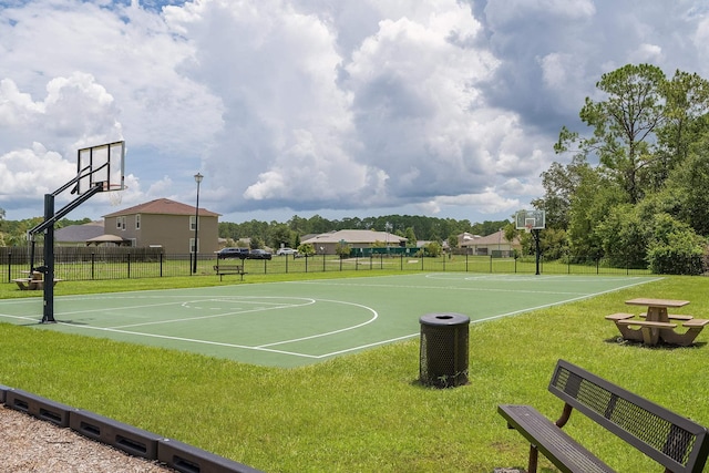 view of basketball court with a yard