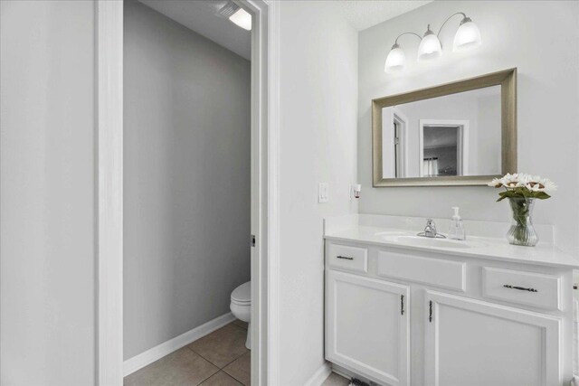 775 E Red House Branch Rd, Saint Augustine, FL 32084 - bathroom featuring toilet, vanity, tile patterned floors, and baseboards