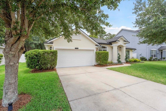 775 E Red House Branch Rd, Saint Augustine, FL 32084 - view of front facade featuring an attached garage, driveway, stucco siding, and a front lawn