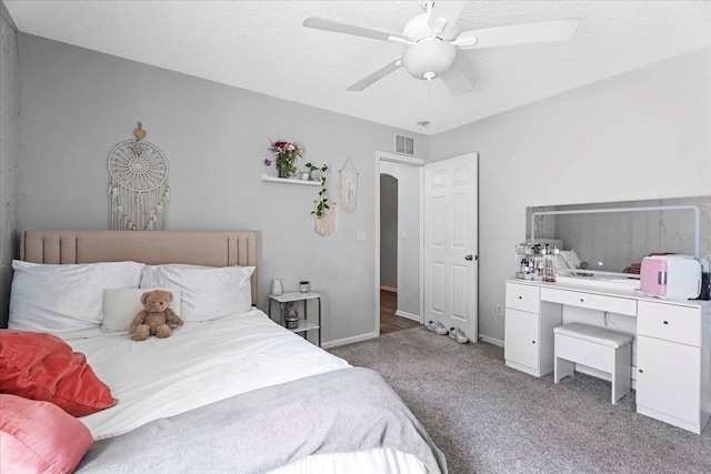 775 E Red House Branch Rd, Saint Augustine, FL 32084 - bedroom with carpet, ceiling fan, arched walkways, baseboards, and a textured ceiling