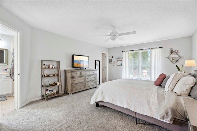 775 E Red House Branch Rd, Saint Augustine, FL 32084 - bedroom with light colored carpet, a textured ceiling, ceiling fan, and ensuite bath
