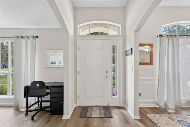 775 E Red House Branch Rd, Saint Augustine, FL 32084 - foyer entrance featuring arched walkways, wood finished floors, and healthy amount of natural light