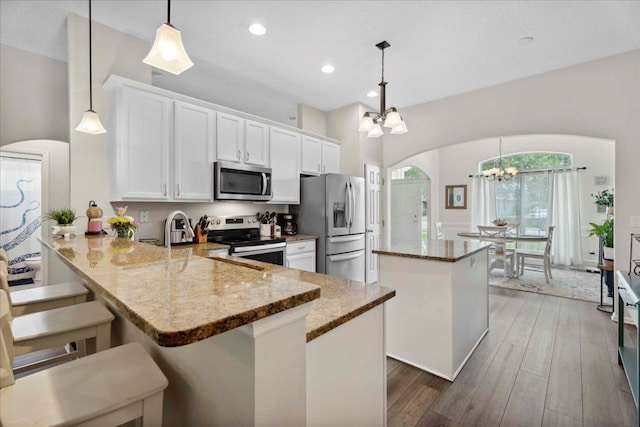 775 E Red House Branch Rd, Saint Augustine, FL 32084 - kitchen featuring stainless steel appliances, arched walkways, a chandelier, a center island, and recessed lighting