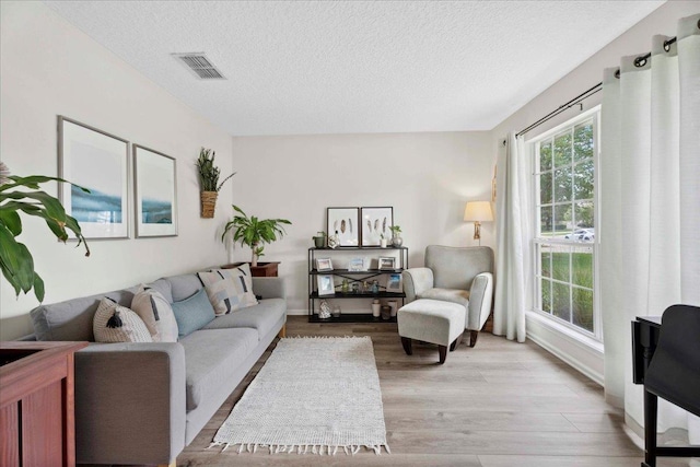 775 E Red House Branch Rd, Saint Augustine, FL 32084 - living area with light wood-style flooring and a textured ceiling