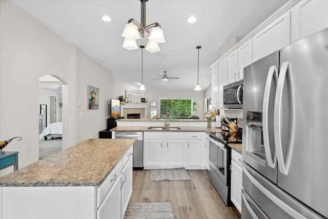 775 E Red House Branch Rd, Saint Augustine, FL 32084 - kitchen featuring stainless steel appliances, a sink, open floor plan, ceiling fan, and light wood-type flooring
