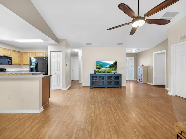 kitchen featuring black appliances, open floor plan, a ceiling fan, light wood-type flooring, and baseboards