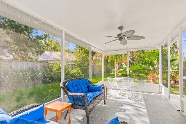 sunroom / solarium featuring a ceiling fan, outdoor lounge area, and outdoor dining space