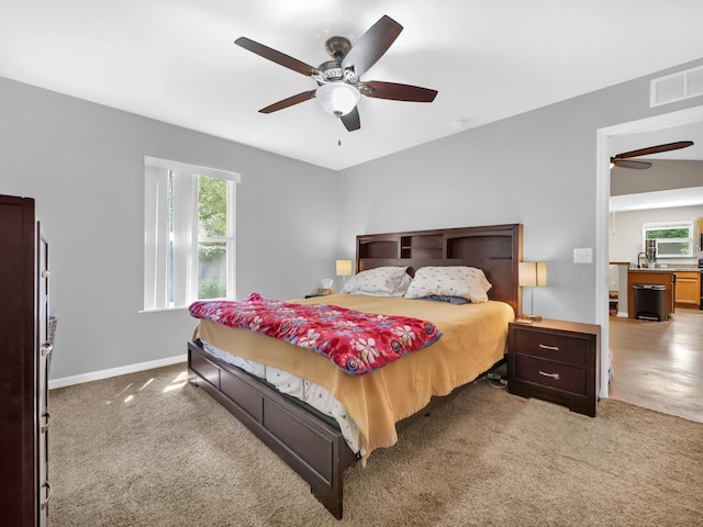 bedroom with multiple windows, carpet floors, and baseboards