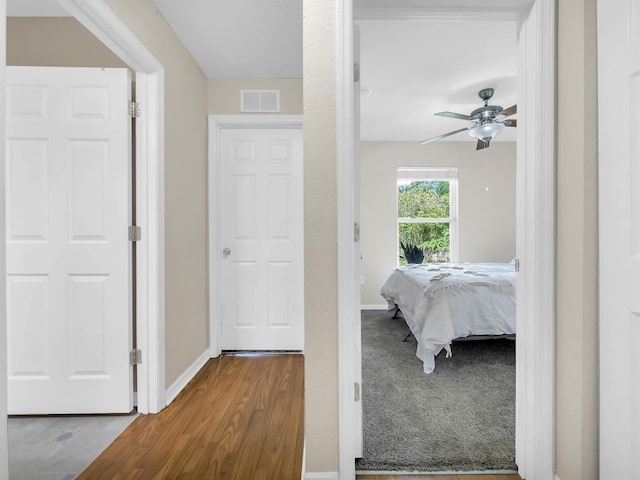 bedroom with baseboards, wood finished floors, and ceiling fan
