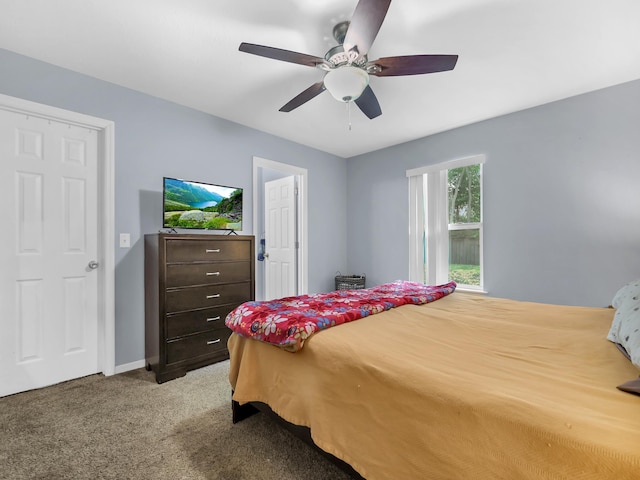bedroom featuring light colored carpet, a ceiling fan, and baseboards