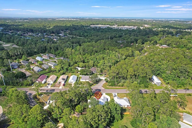 aerial view of property and surrounding area featuring a forest