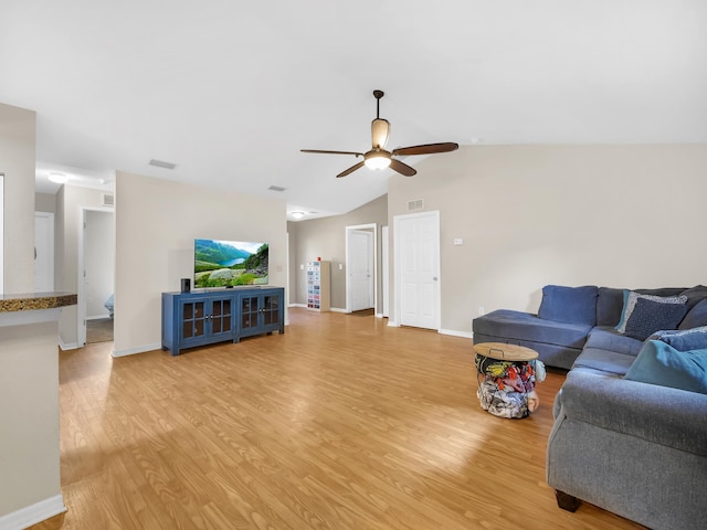 living room with light wood finished floors, a ceiling fan, baseboards, and lofted ceiling