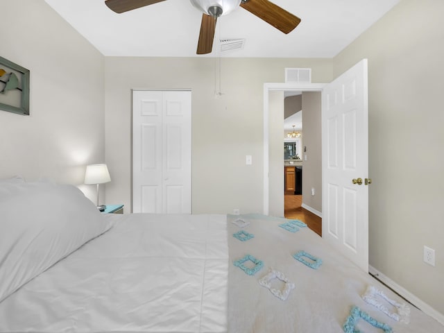 bedroom with a closet, a ceiling fan, baseboards, and wood finished floors
