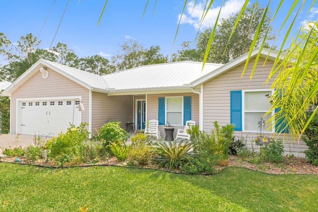 ranch-style home featuring a garage, a porch, a front yard, metal roof, and driveway