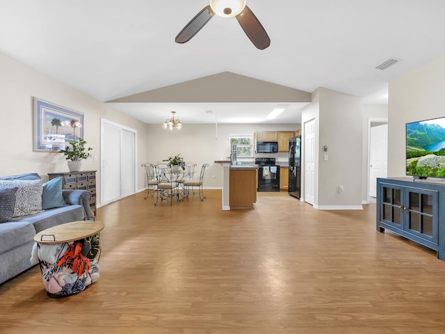 living area with light wood-style floors, ceiling fan, vaulted ceiling, and baseboards