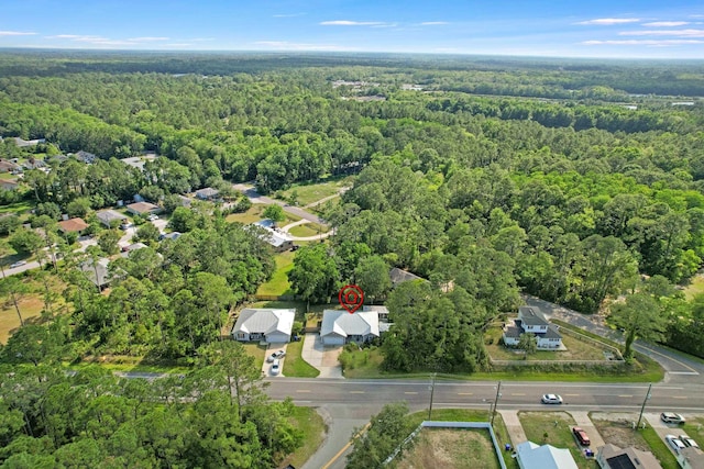 aerial view of property's location featuring a heavily wooded area