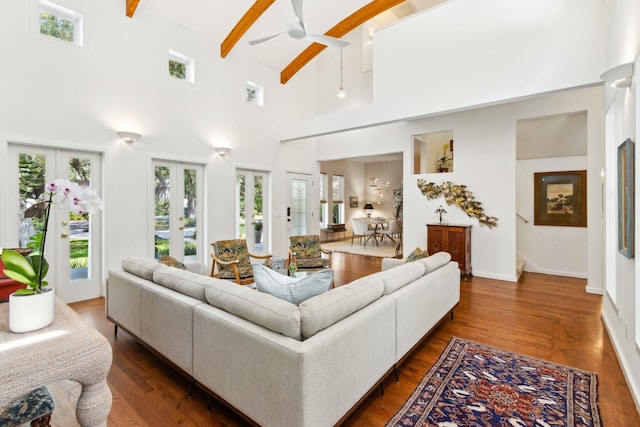 136 Island Hammock Way, Saint Augustine, FL 32080 - living room with a ceiling fan, beam ceiling, dark wood-style flooring, a high ceiling, and baseboards