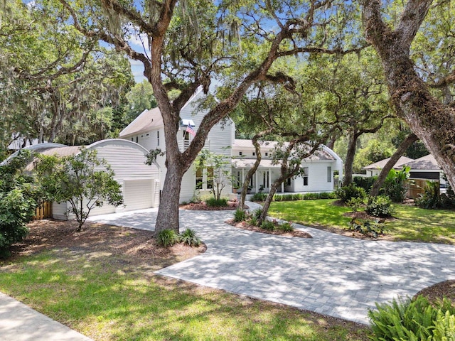 136 Island Hammock Way, Saint Augustine, FL 32080 - view of property hidden behind natural elements with driveway, a front yard, and a garage