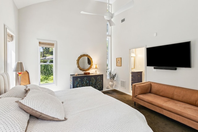136 Island Hammock Way, Saint Augustine, FL 32080 - bedroom featuring a towering ceiling, ensuite bath, baseboards, a ceiling fan, and dark colored carpet