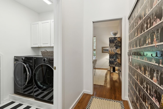 136 Island Hammock Way, Saint Augustine, FL 32080 - laundry area with washer and clothes dryer, dark wood-style flooring, cabinet space, and baseboards