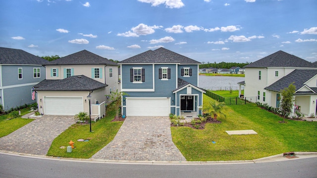 front facade with a garage and a front lawn