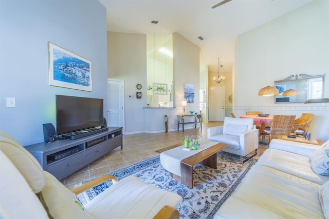 living room with light tile patterned floors, high vaulted ceiling, and a chandelier