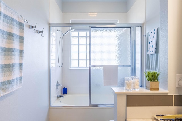 bathroom featuring bath / shower combo with glass door