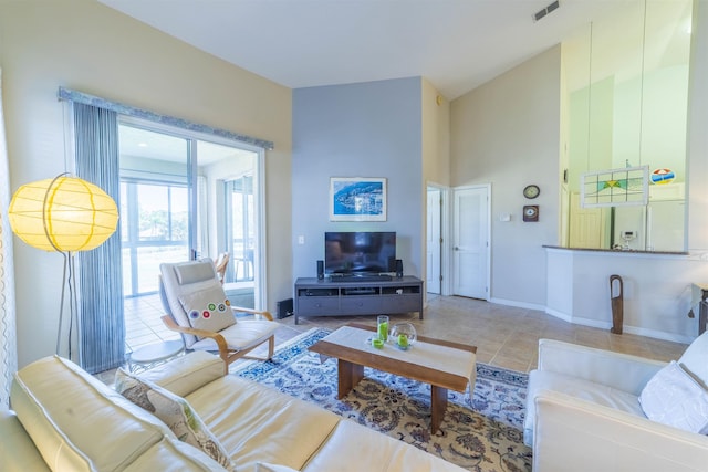 tiled living room featuring a high ceiling