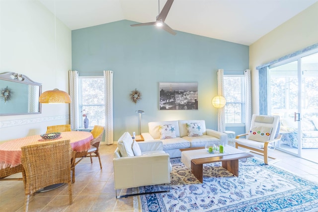 living room featuring lofted ceiling, plenty of natural light, ceiling fan, and light tile patterned flooring