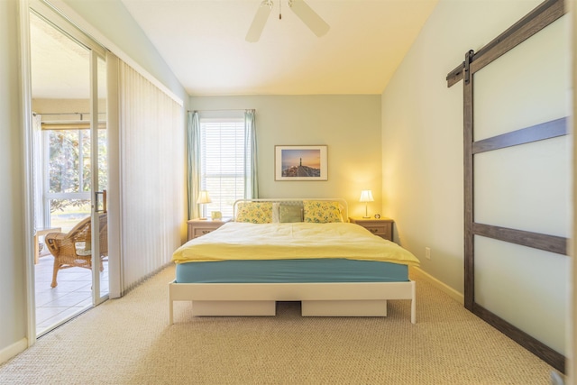 carpeted bedroom with a barn door, access to exterior, vaulted ceiling, and multiple windows