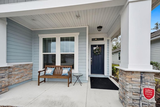 doorway to property featuring a porch