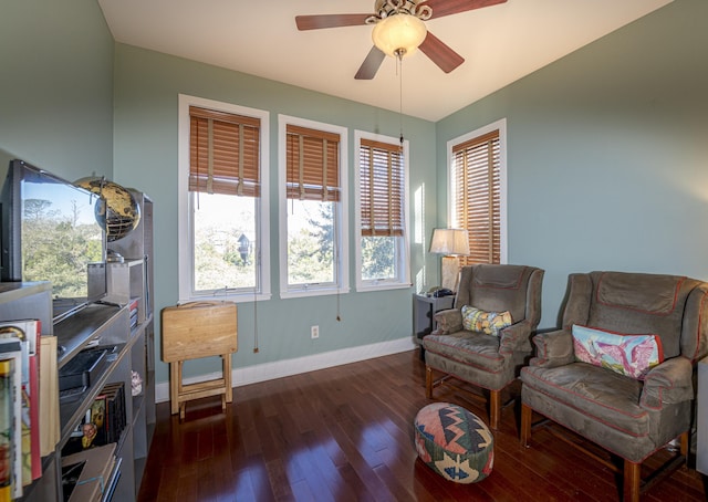 living area with dark hardwood / wood-style flooring and ceiling fan