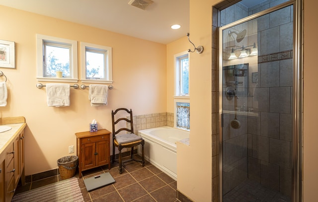 bathroom with plenty of natural light, tile patterned floors, and separate shower and tub