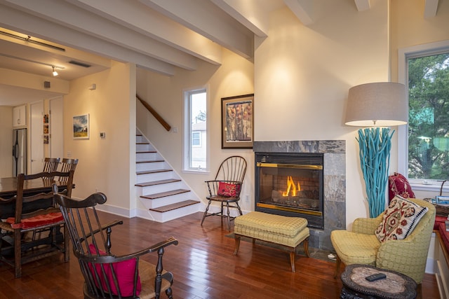 sitting room with dark hardwood / wood-style flooring, plenty of natural light, a tile fireplace, and track lighting