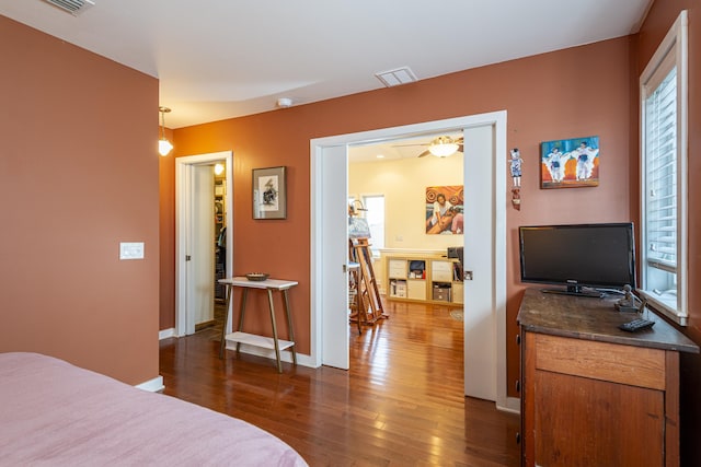 bedroom with dark hardwood / wood-style flooring