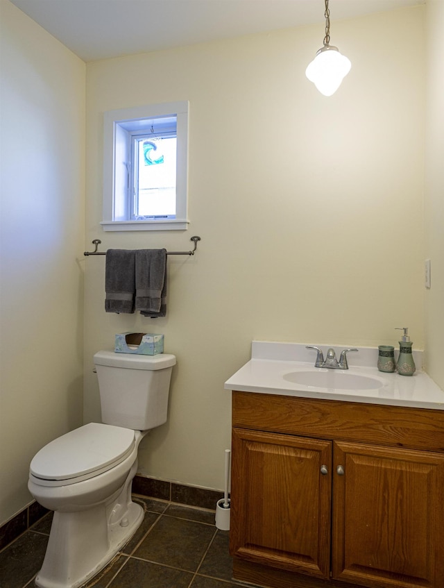 bathroom with vanity, tile patterned floors, and toilet