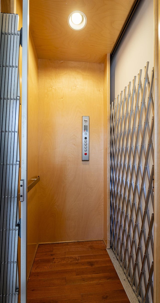 room details featuring wood-type flooring and elevator