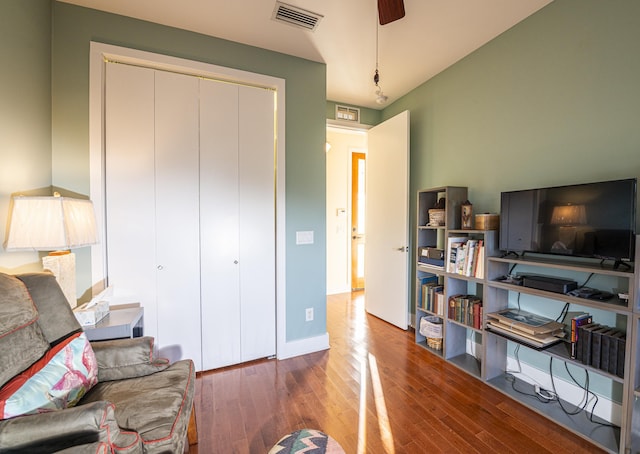 living room featuring ceiling fan and wood-type flooring