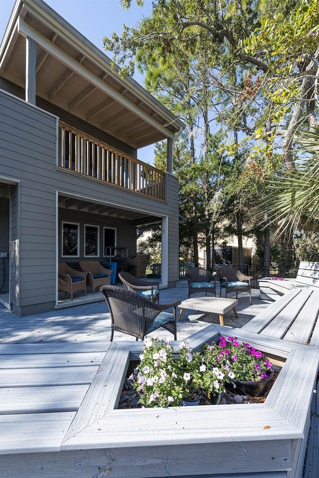 wooden deck with an outdoor living space