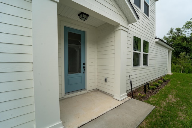 doorway to property with a yard