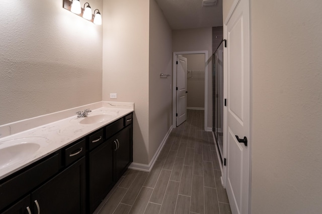 bathroom with vanity, wood-type flooring, and walk in shower