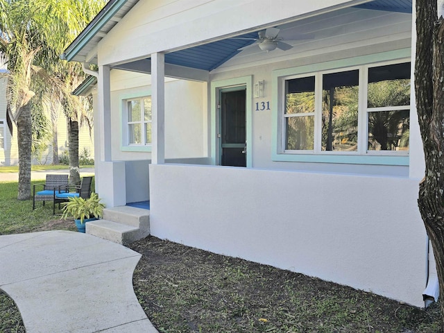 doorway to property with ceiling fan