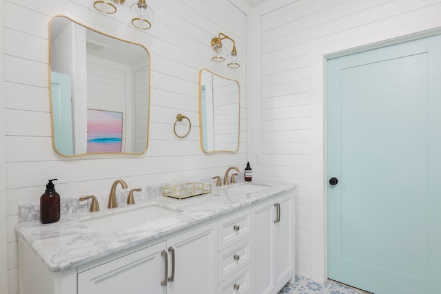 bathroom featuring vanity and wooden walls