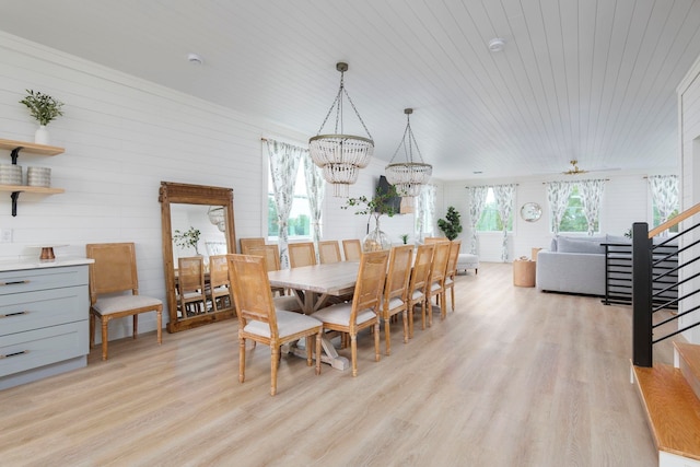 dining space featuring light hardwood / wood-style floors, a notable chandelier, a healthy amount of sunlight, and wood ceiling